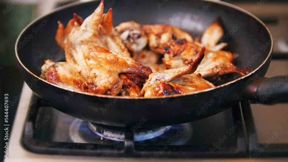 Frying Chicken wings prepared in pan - Home food