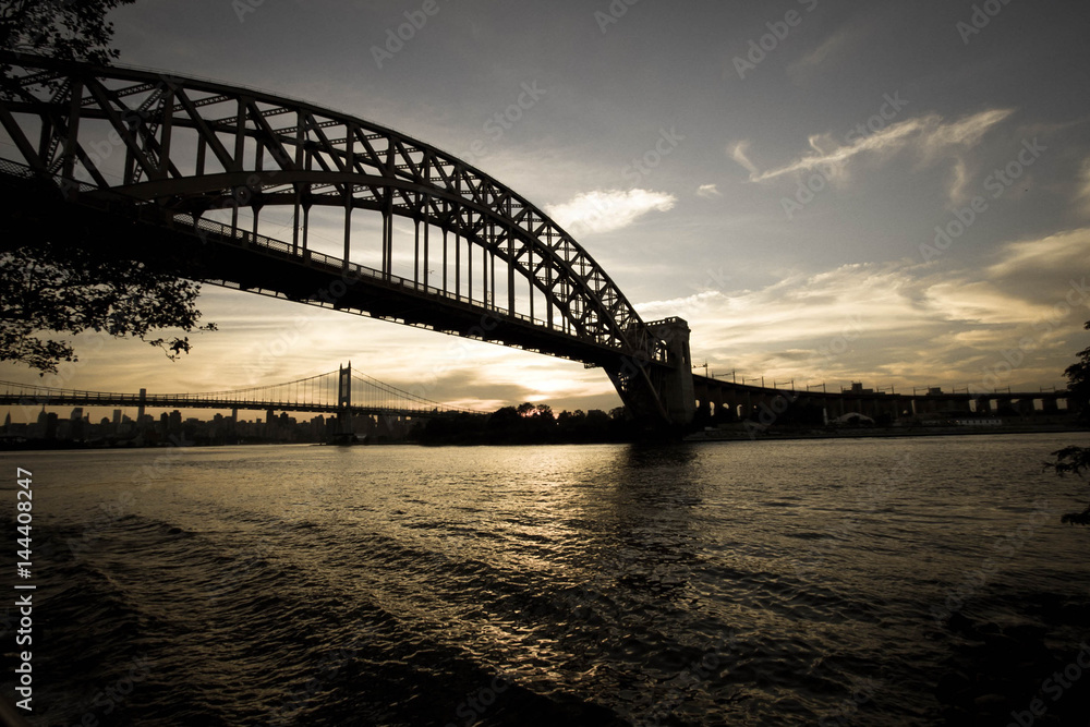 Dark Silhouette of Hell Gate Bridge and Triborough bridge over the river in vintage style, New York Dark Silhouette of Hell Gate Bridge and Triborough bridge over the river in vintage style, New York