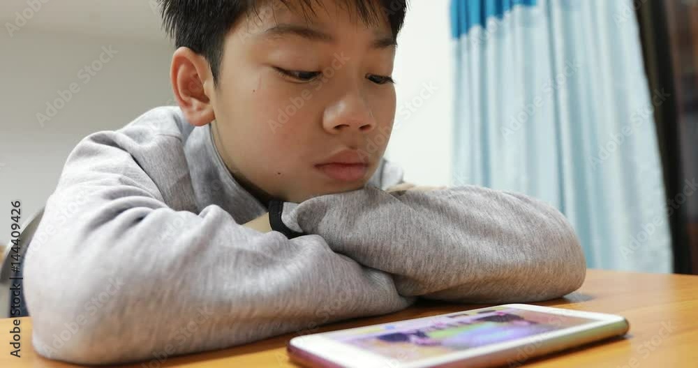 Young child watching video on a mobile phone Young child watching video on a mobile phone