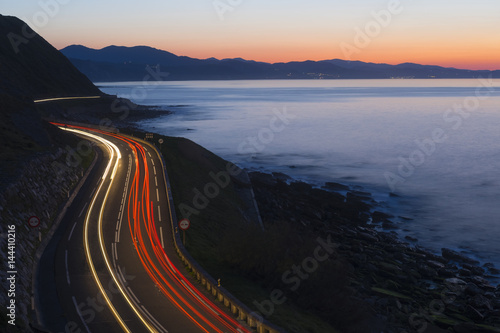 Car lights on the road at night by the sea, Gipuzkoa