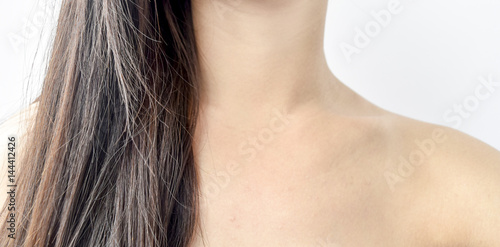 Close up portrait of beautiful young aged woman with brown hair and shoulder , isolated on white background - beauty concept