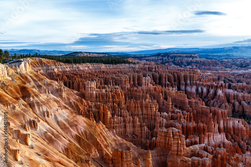 Panoramic view of Bryce Canyon National Park's "Amphitheater" with colorful cliffs and hoodoos in the early morning.