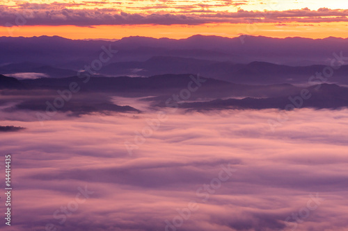 Morning scene of fog on high hill landscape along the valley and sunrise atmosphere from mountain peak.