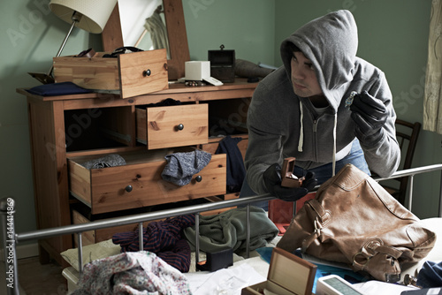 Obraz na plátne Burglar Stealing Items From Bedroom During Hose Break In