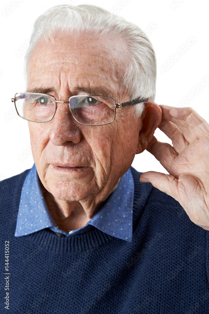 Studio Shot Of Senior Man Suffering From Deafness Studio Shot Of Senior Man Suffering From Deafness