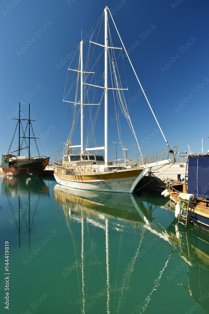boats and yachts in the port on the background of city