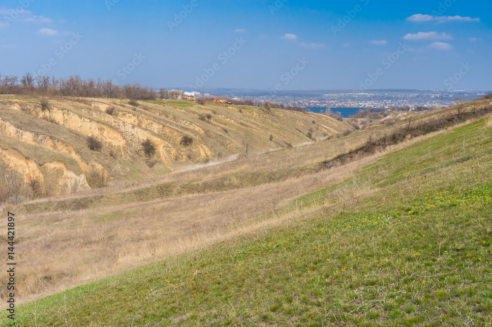 Sunny landscape with soil erosion at early spring season in outskirts of Dnepr city, Ukraine
