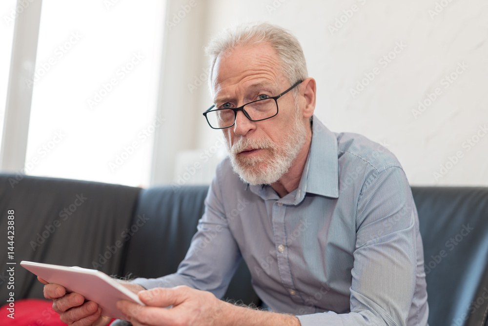 Portrait of senior man using a tablet Portrait of senior man using a tablet