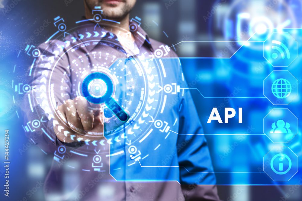 Business, Technology, Internet and network concept. Young businessman working on a virtual screen of the future and sees the inscription: API Business, Technology, Internet and network concept. Young businessman working on a virtual screen of the future and sees the inscription: API