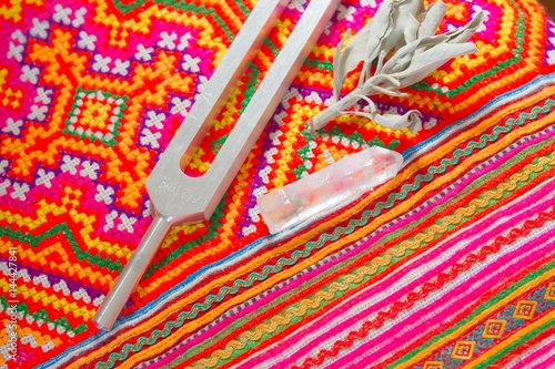 tuning fork and crystal on table .
