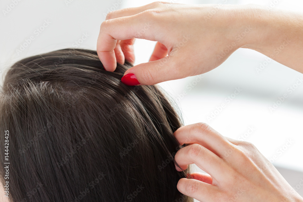 Fototapeta premium Hairdresser does hair style of woman