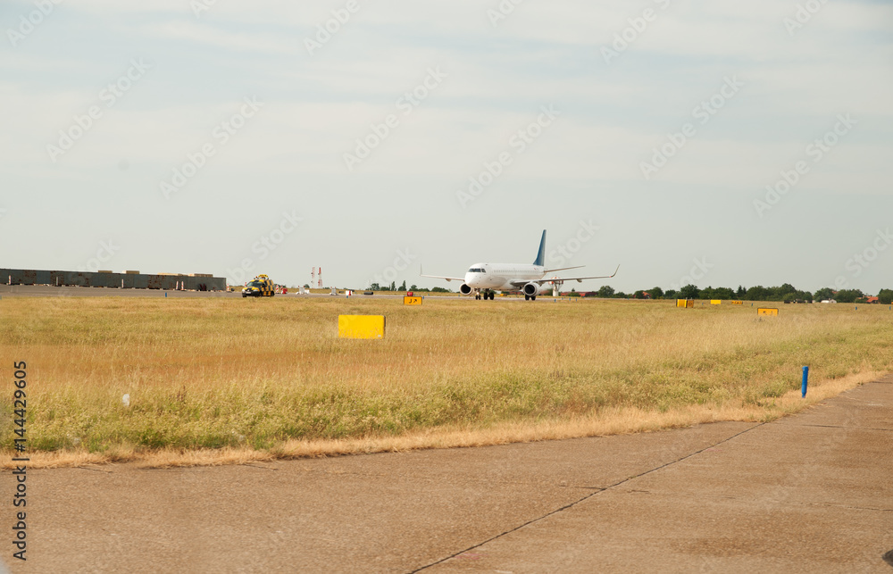 Fototapeta premium Airplane taxiing on the runway, preparing departure - take off after landing