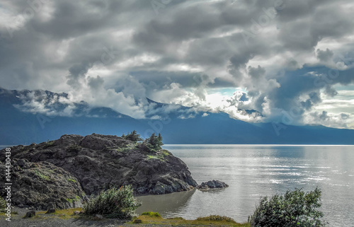 Alaska sea at Anchorage at sunset with clouds and reflections