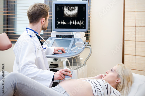 Pregnant woman at the doctor. Ultrasound diagnostic machine