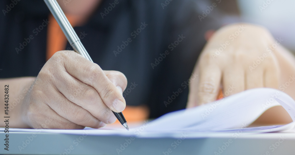 university students hand writing doing examination with blurred abstract background in exam classroom, educational college university students hand writing doing examination with blurred abstract background in exam classroom, educational college
