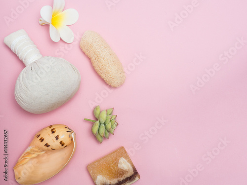 Aromatherapy product Spa set ,candle ,soap,coconut,flower,shell, massage with pink color background .