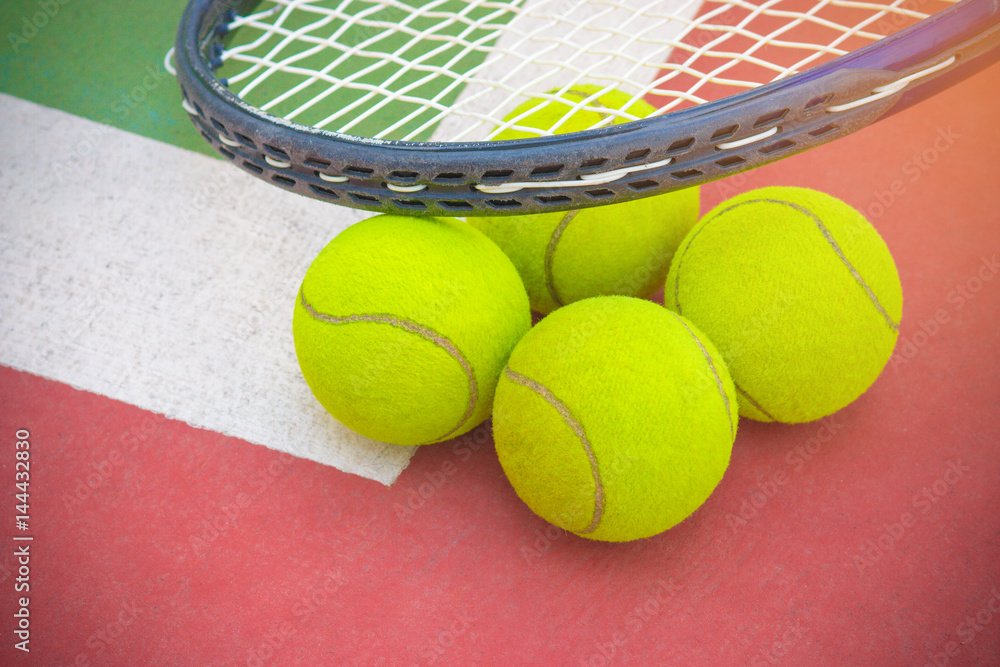 Tennis Ball with Racket on the racket in tennis court