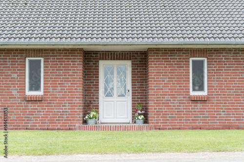 Eingangsbereich eines Hauses mit Haustür und Fenstern © GM Photography