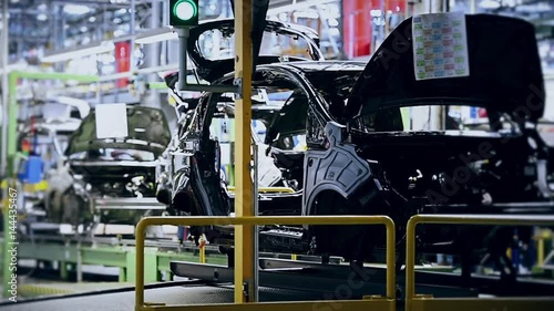 Car bodies on the production line inside automobile factory