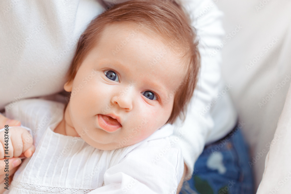 Young mother and newborn baby in white bedroom Young mother and newborn baby in white bedroom