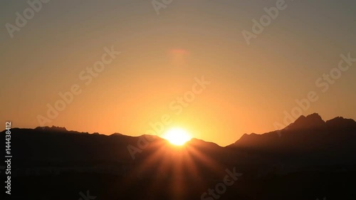 Time lapse of beautiful sunrise over mountain  photo