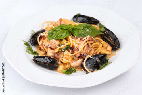 Seafood pasta with basil and parmesan isolated