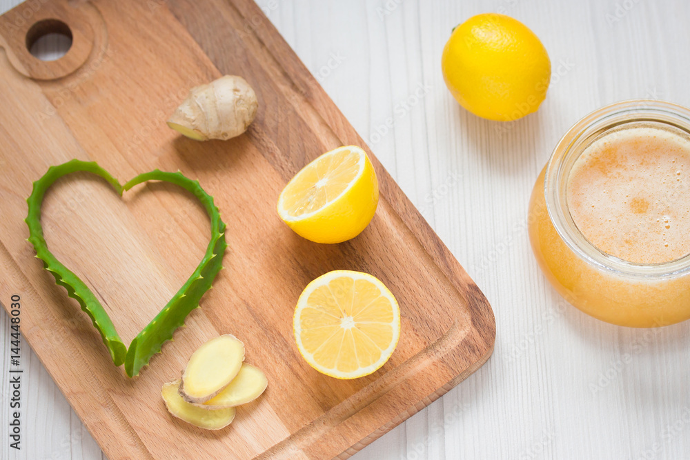 Aloe, lemon, ginger and honey on wooden background Aloe, lemon, ginger and honey on wooden background