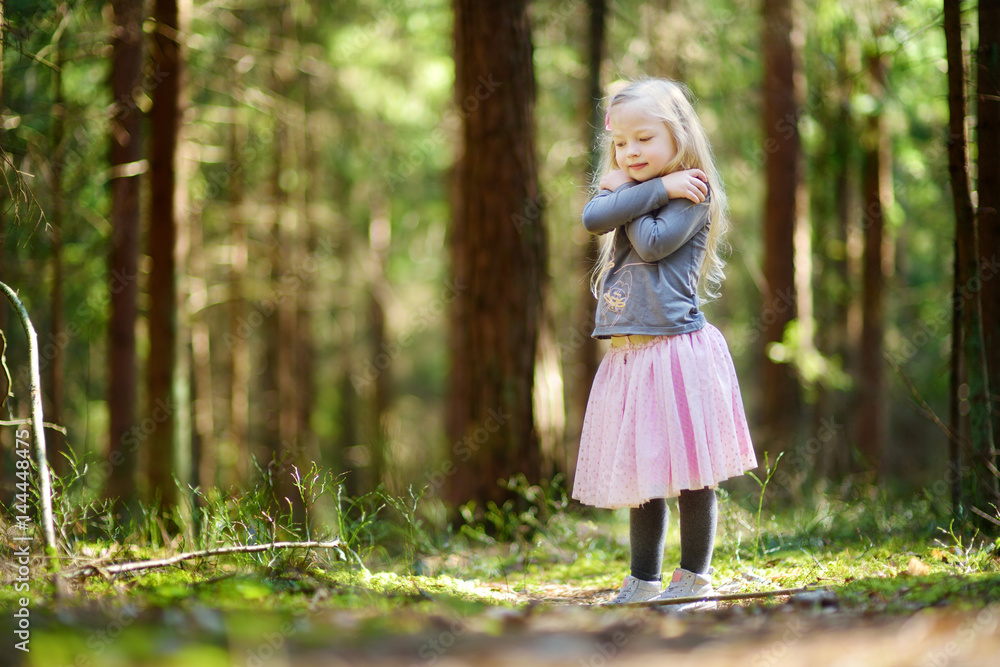 Cute little girl having fun during forest hike on beautiful spring day. Cute little girl having fun during forest hike on beautiful spring day.