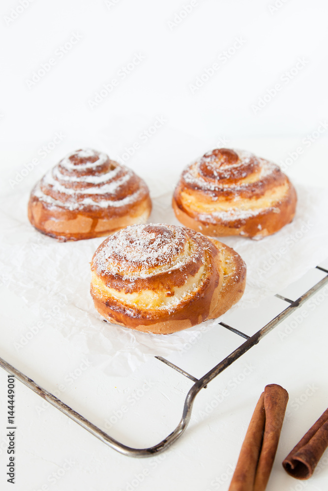 Sweet rolls with sugar and cinnamon on white background.