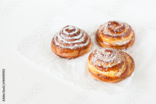 Sweet rolls with sugar and cinnamon on white background.