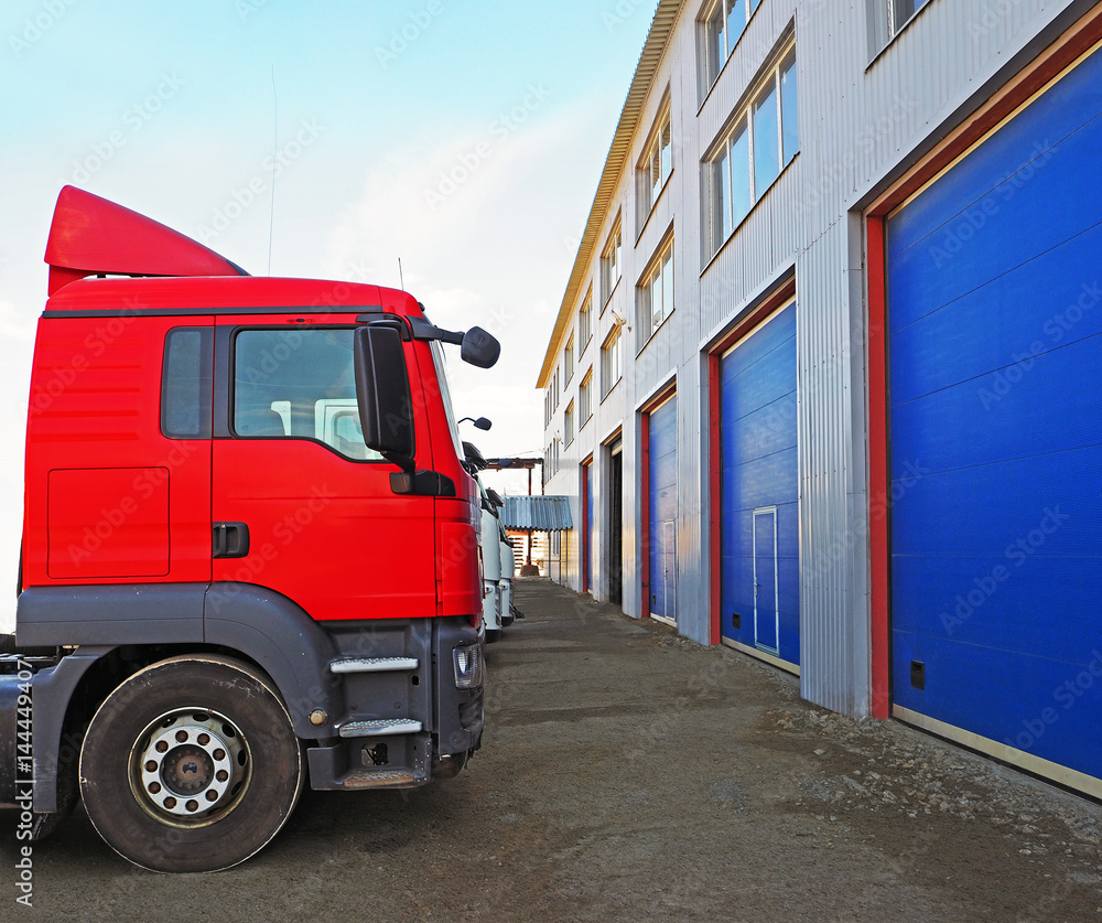 Fototapeta premium Storage and freight terminal. Industrial background. Terminal for truck loading with closed gates. Logistics.