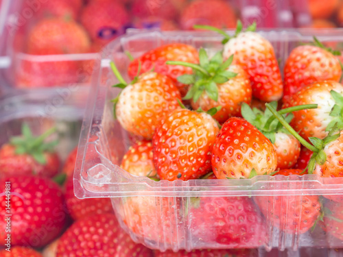 Closeup of strawberry in plastic box.