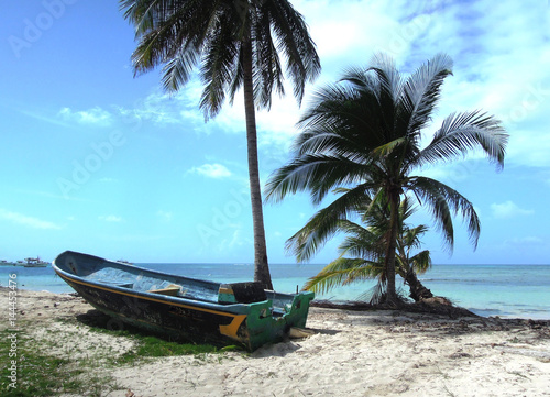 Big Corn Island Nicaragua fishing panga boat beach with palm coconut trees Caribbean Sea  Central America photo