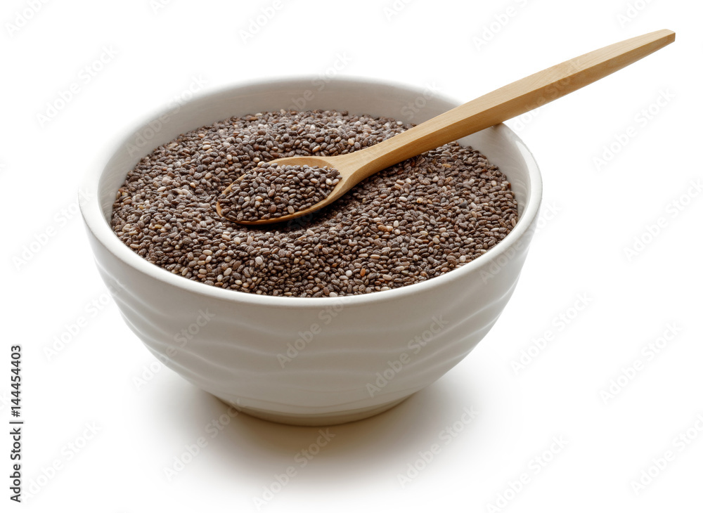 Chia seeds in a bowl with wooden spoon Chia seeds in a bowl with wooden spoon