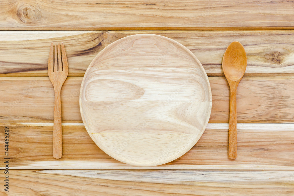 Wooden plate with spoon and fork. Wooden plate with spoon and fork.
