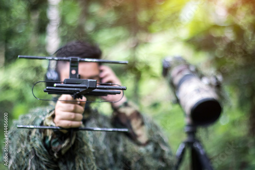 An ornithologist using radio telemetry,tracking to find an bird