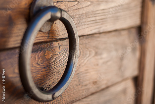 Old metallic handle on a wooden door