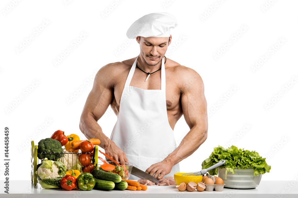 Man bodybuilder in white toque blanche and cook protective apron Man bodybuilder in white toque blanche and cook protective apron
