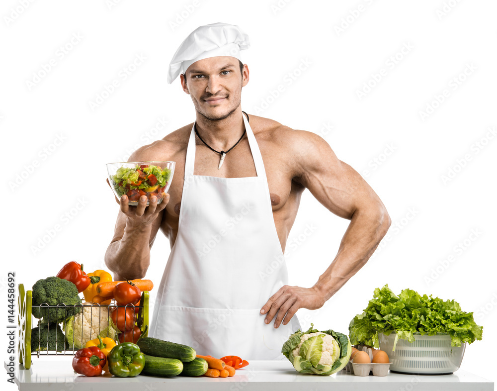 Man bodybuilder in white toque blanche and cook protective apron Man bodybuilder in white toque blanche and cook protective apron