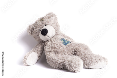 teddy bear with a patch on a white background