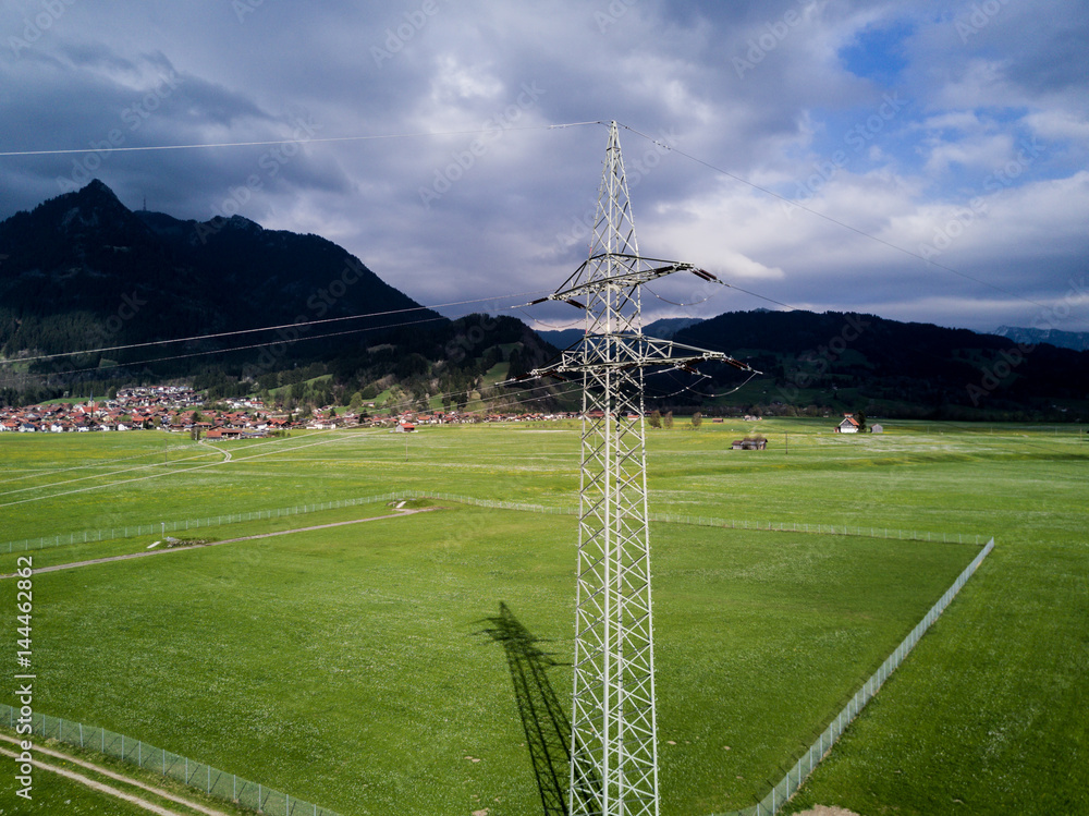 Obraz premium Power line on green meadow