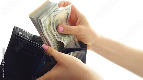 hands counting money and put in a wallet closeup