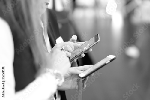 Two women receive information from their smartphones