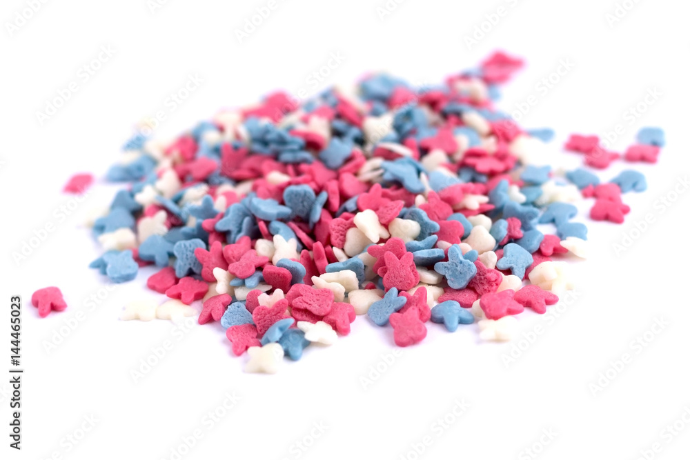 White pink and blue sprinkles on white background White pink and blue sprinkles on white background