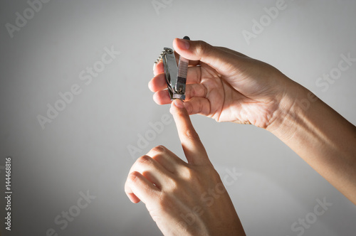 Woman use clipper cut her fingernails.