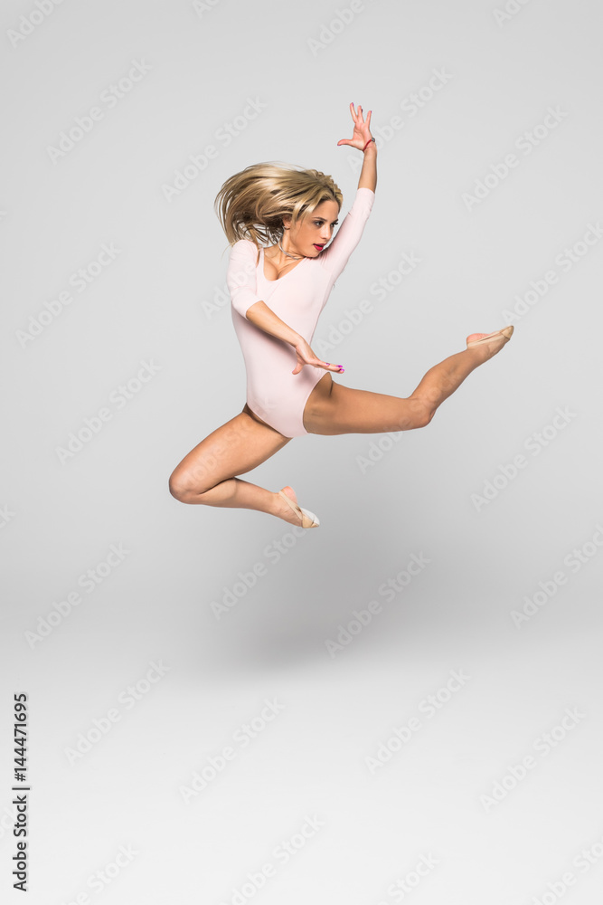 Pretty woman dancer jumper on isolated white background