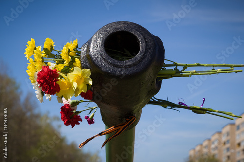 Beautifrul flowers in the barrel of the tank. May 9th. Victory day in Russia. Peace in the world. Memorial day photo