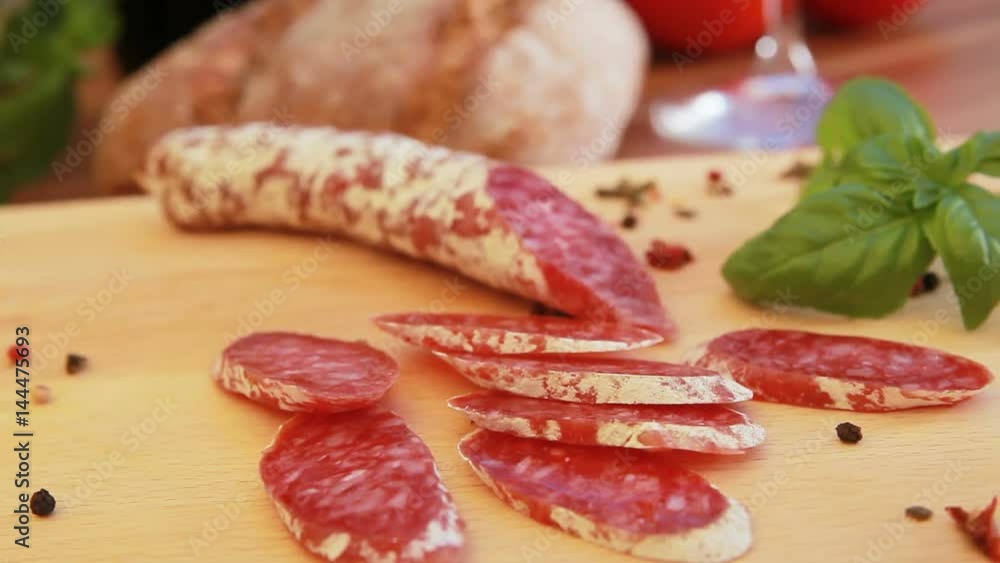 Cured homemade salami on a wooden board Cured homemade salami on a wooden board