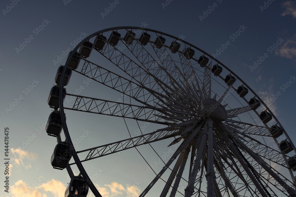 part of a big wheel with boxes against the background of the dark evening sky