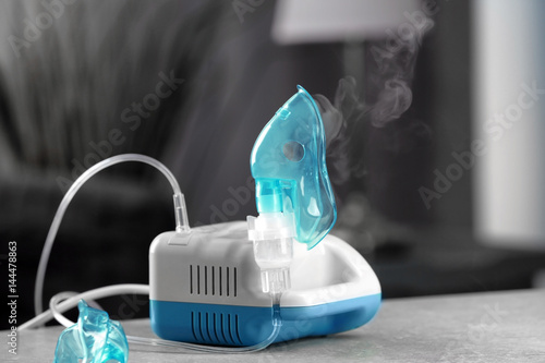 Compressor nebulizer with mask on table photo